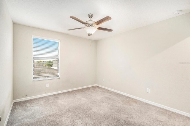 carpeted empty room with ceiling fan