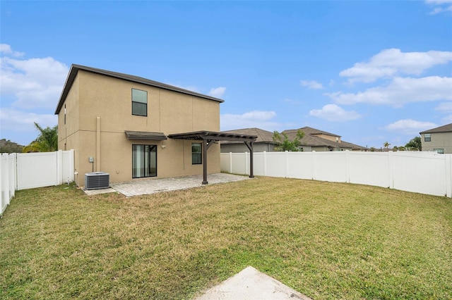 rear view of house with central AC unit, a patio, a lawn, and a pergola