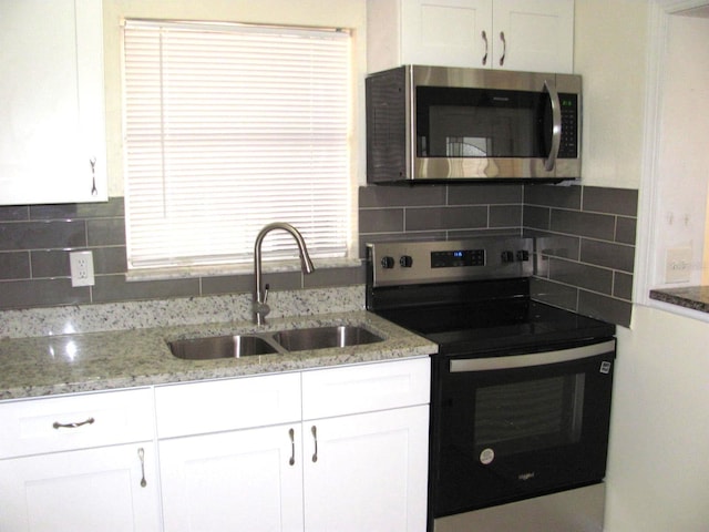 kitchen featuring sink, white cabinets, and appliances with stainless steel finishes