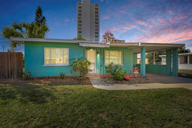 view of front facade featuring a carport and a yard