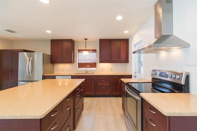 kitchen with a center island, stainless steel appliances, sink, hanging light fixtures, and ventilation hood