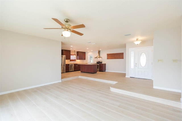 unfurnished living room with ceiling fan