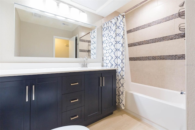 bathroom featuring vanity and shower / bathtub combination with curtain