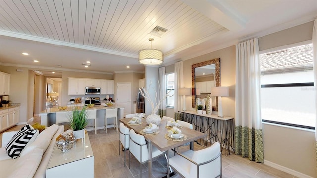 dining room with ornamental molding and wooden ceiling