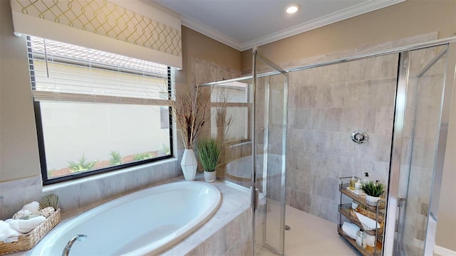 bathroom with ornamental molding and shower with separate bathtub