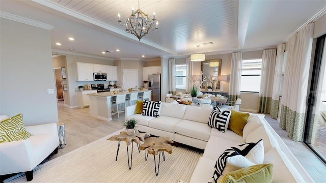 living room featuring crown molding and a chandelier