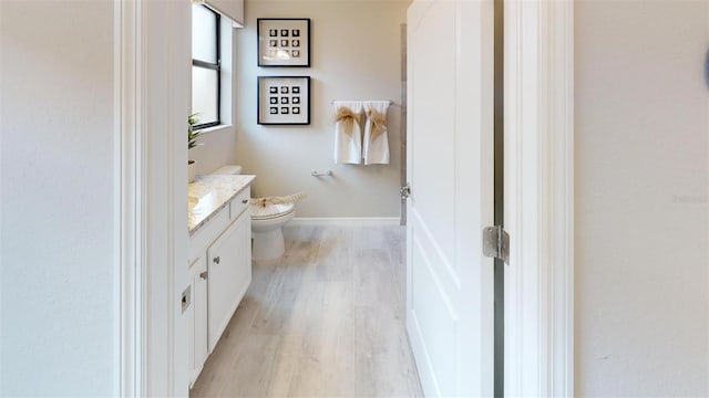 bathroom with vanity, hardwood / wood-style floors, and toilet