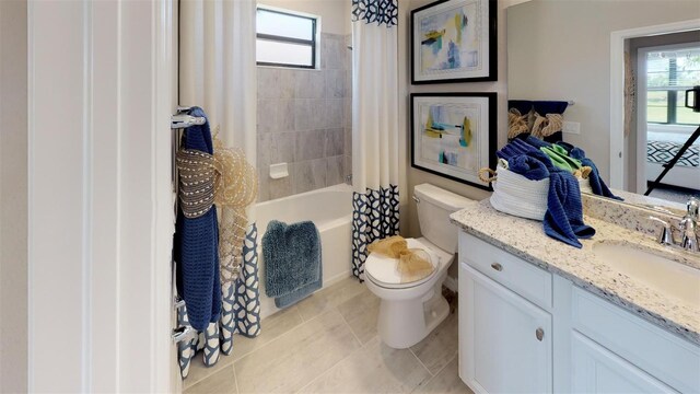 full bathroom with tile patterned floors, vanity, toilet, and shower / bath combo with shower curtain