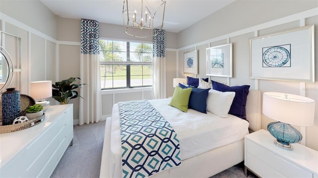 bedroom with an inviting chandelier and carpet