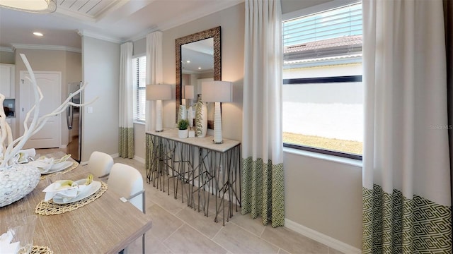 interior space featuring light tile patterned floors, a wealth of natural light, and ornamental molding