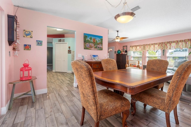 dining area with ceiling fan and light hardwood / wood-style flooring