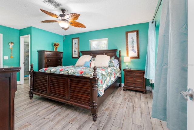 bedroom with ceiling fan and light hardwood / wood-style flooring