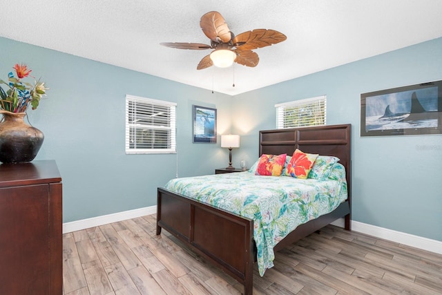 bedroom with light wood-type flooring and ceiling fan