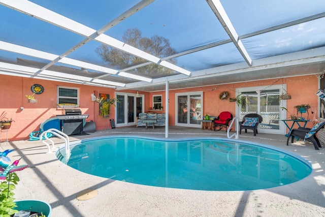 view of swimming pool with a patio area, a lanai, and a grill