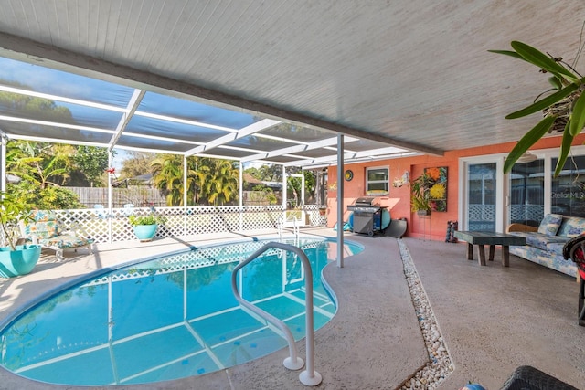 view of swimming pool with a patio area and glass enclosure