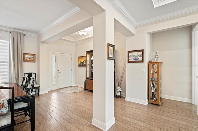 foyer featuring crown molding and light hardwood / wood-style floors