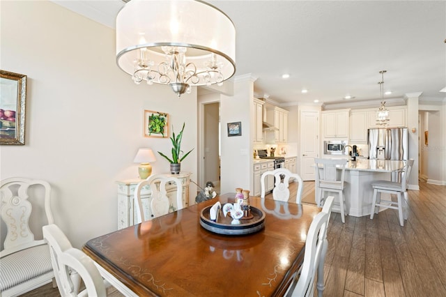 dining area featuring crown molding, dark wood-type flooring, and a chandelier