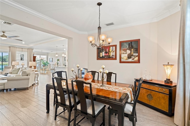 dining room featuring ceiling fan with notable chandelier, light hardwood / wood-style flooring, and ornamental molding