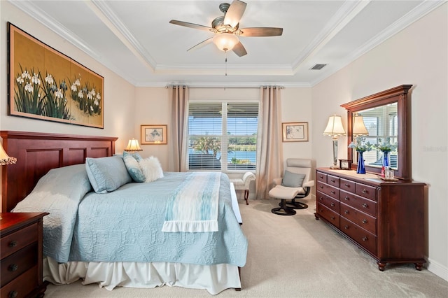 bedroom featuring crown molding, light colored carpet, a raised ceiling, and ceiling fan