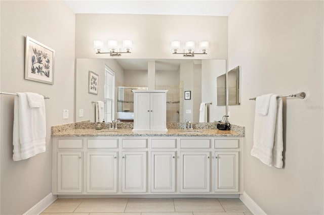 bathroom with tile patterned floors, vanity, and a shower with shower door