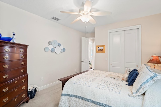 carpeted bedroom featuring ceiling fan and a closet