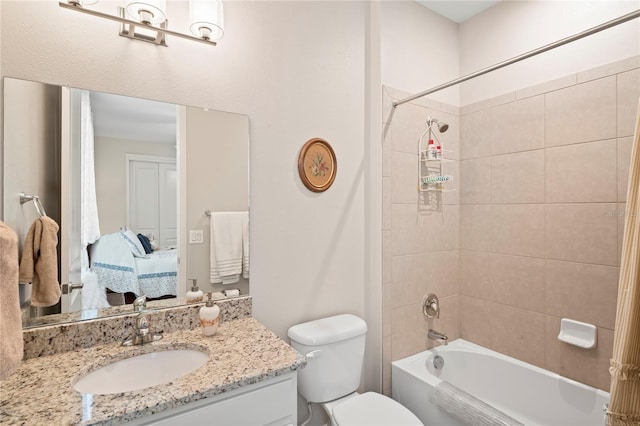 full bathroom with vanity, toilet, and tiled shower / bath combo