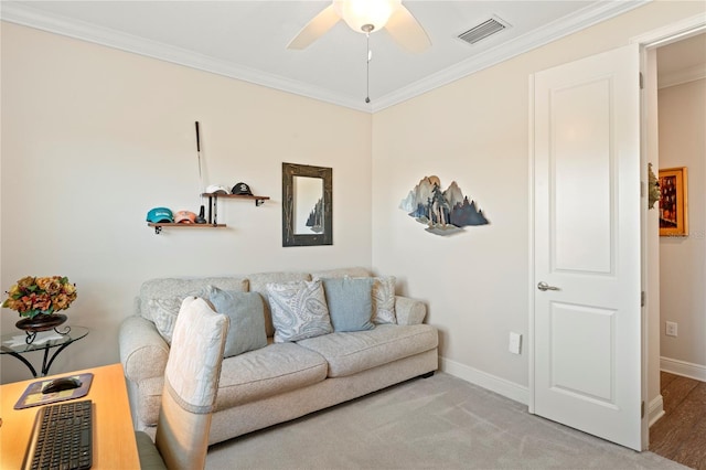 carpeted living room featuring crown molding and ceiling fan