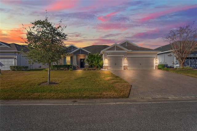 view of front of property featuring a yard and a garage