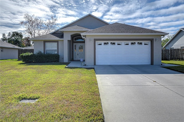 ranch-style house featuring a front lawn and a garage