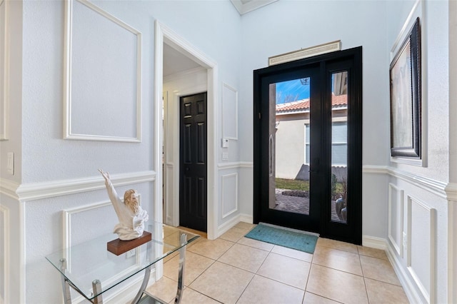 tiled entrance foyer with crown molding