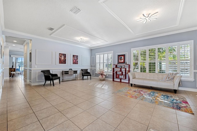 tiled living room with ornamental molding and a textured ceiling