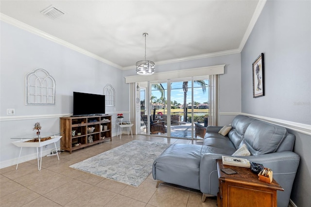 tiled living room featuring crown molding and a chandelier