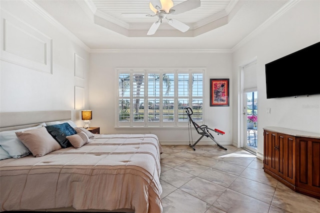 bedroom with a raised ceiling, access to exterior, and multiple windows