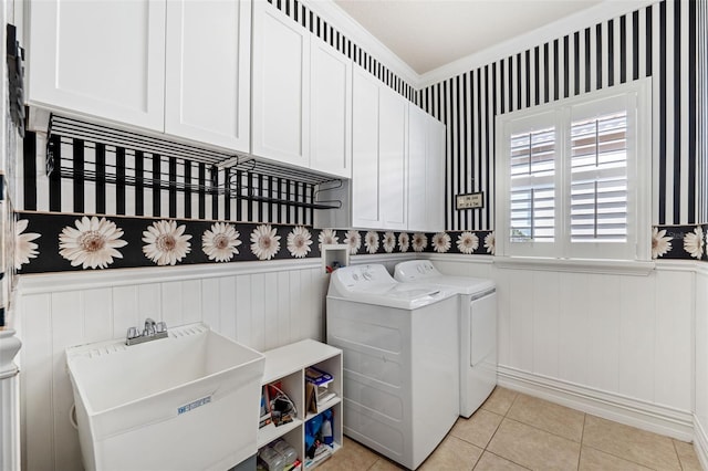 laundry room with light tile patterned flooring, cabinets, separate washer and dryer, and sink