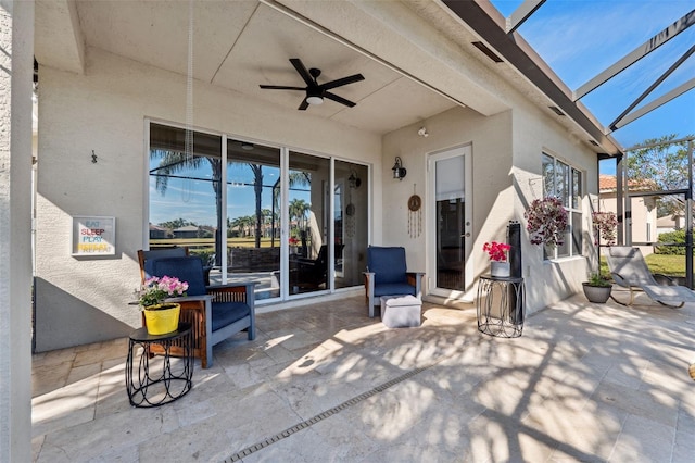 view of patio / terrace with ceiling fan and glass enclosure