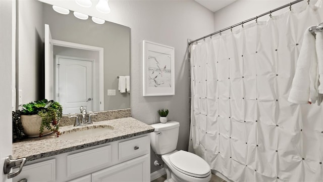 bathroom featuring vanity, toilet, and a shower with shower curtain