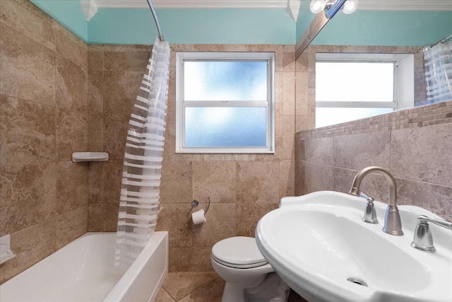 full bathroom with tile patterned floors, sink, tile walls, toilet, and shower / bath combo with shower curtain