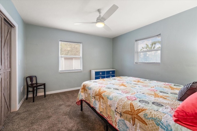 bedroom featuring ceiling fan, a closet, dark colored carpet, and multiple windows