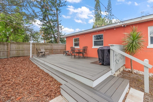 wooden terrace featuring area for grilling