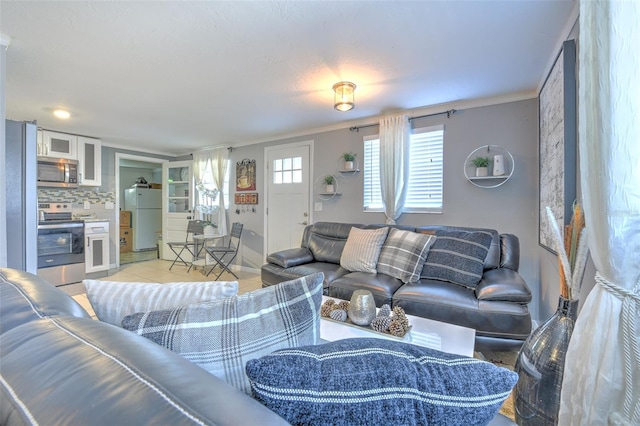 living room with crown molding and light tile patterned flooring