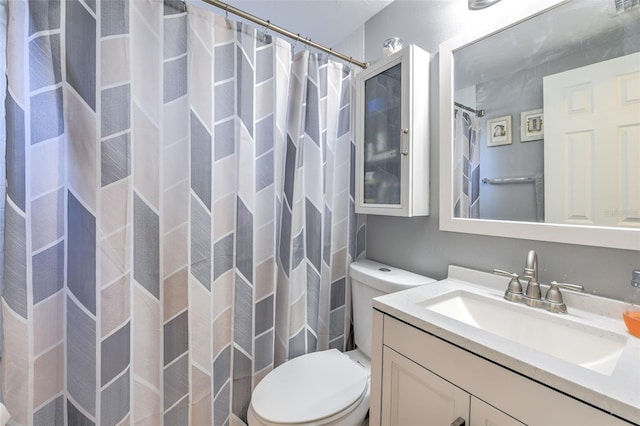 bathroom featuring vanity, a shower with shower curtain, and toilet