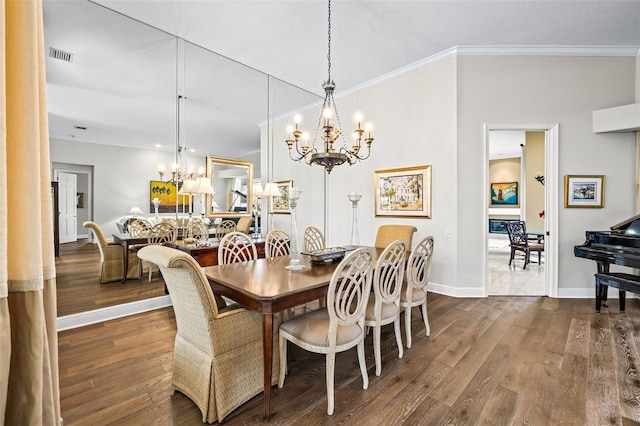 dining space featuring an inviting chandelier, dark hardwood / wood-style flooring, and ornamental molding