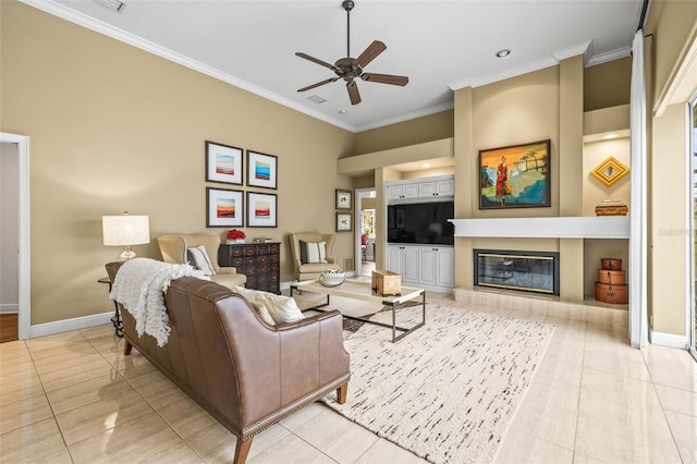 living room featuring light tile patterned flooring, ornamental molding, a tile fireplace, built in features, and ceiling fan