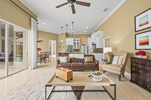 living room with ornamental molding, light tile patterned floors, and ceiling fan