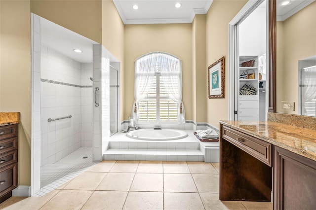 bathroom with vanity, crown molding, tile patterned floors, and plus walk in shower