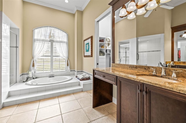 bathroom with vanity, tiled tub, tile patterned floors, and ornamental molding