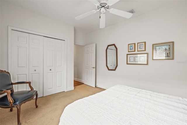 carpeted bedroom featuring ceiling fan and a closet