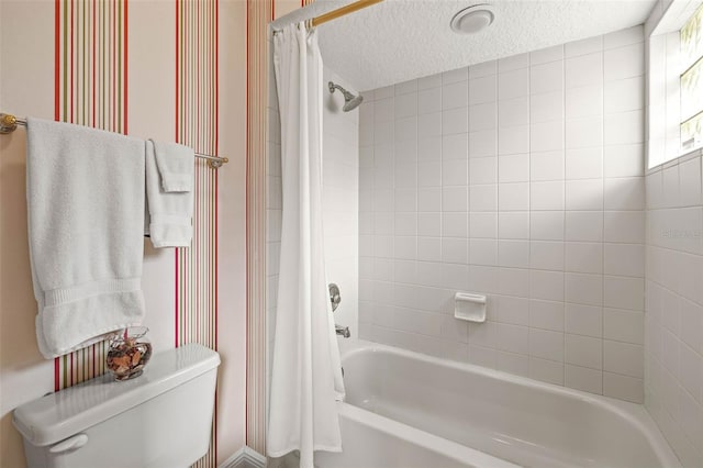 bathroom with shower / tub combo, toilet, and a textured ceiling