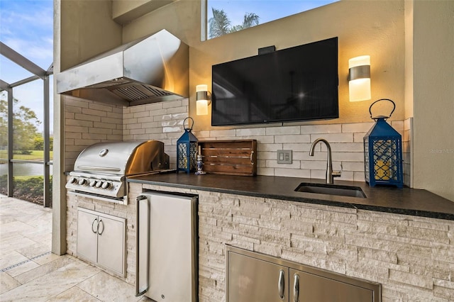 view of patio featuring area for grilling, a lanai, sink, and an outdoor kitchen