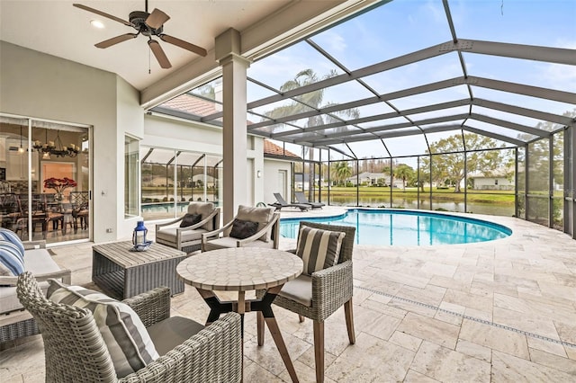 view of pool with ceiling fan, a lanai, and a patio